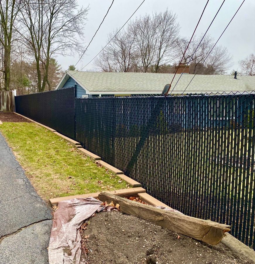 Black chain link fence with privacy slats