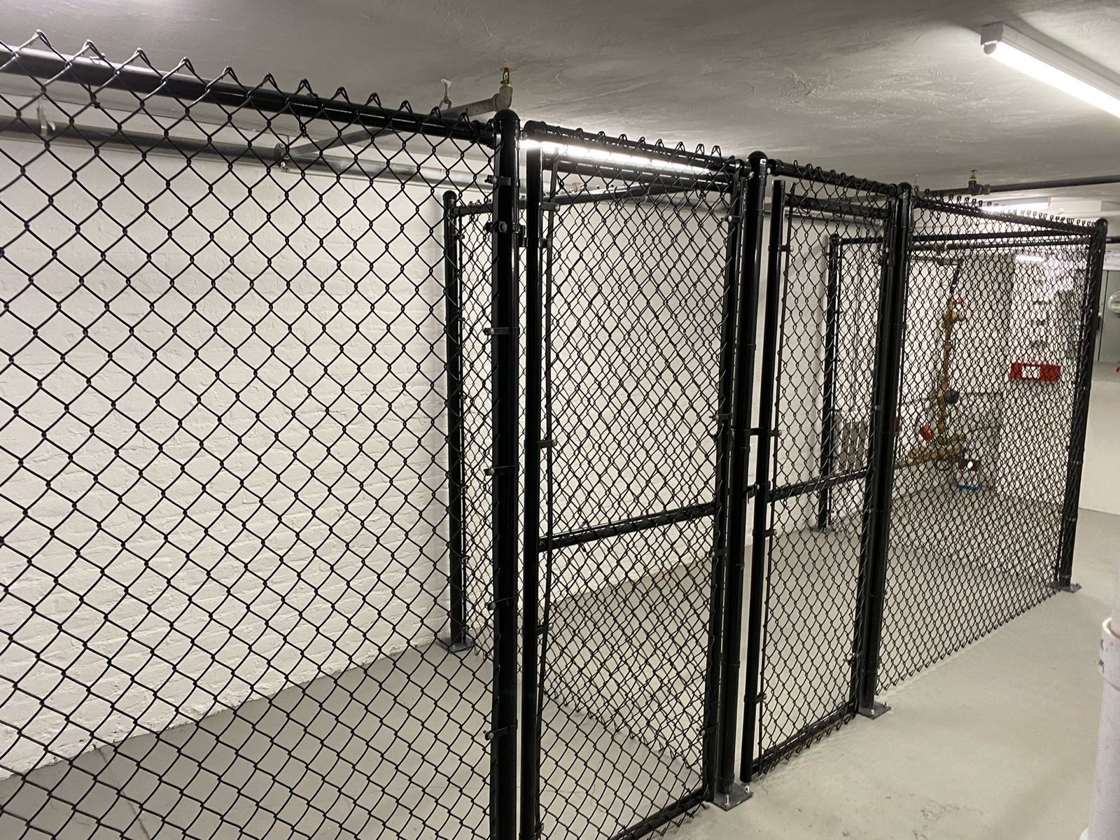 Black chain link storage enclosure with gates