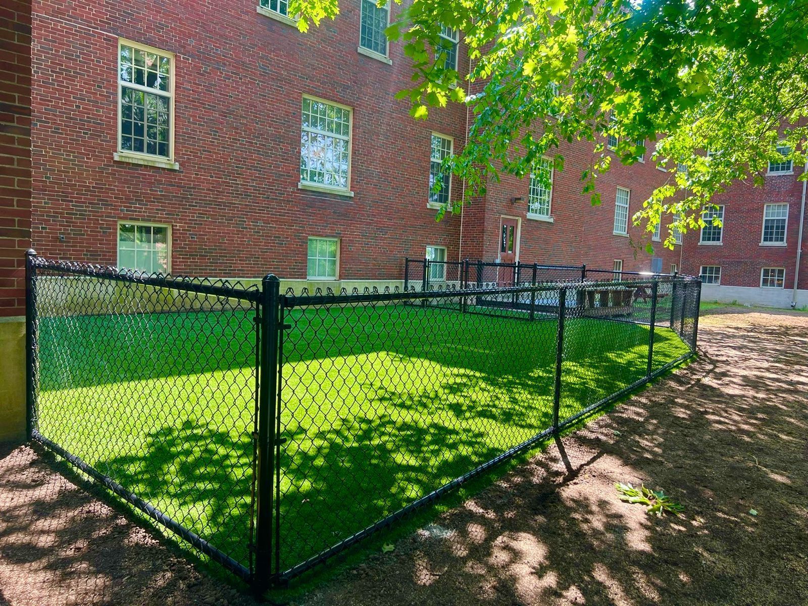 Black chain link fence enclosing a courtyard